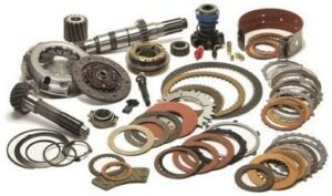 a collection of transmission parts, including clutch plates, gaskets, and gears, which are commonly used in transmission rebuild kits.