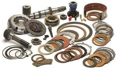 a collection of transmission parts, including clutch plates, gaskets, and gears, which are commonly used in transmission rebuild kits.